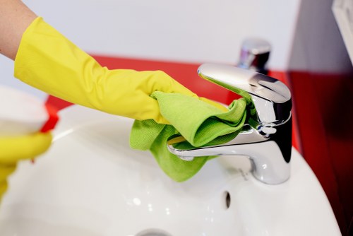 Technician applying safe chemical handling procedures during carpet cleaning