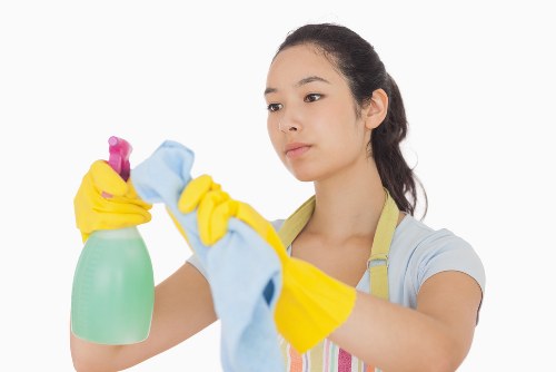 Technician wearing protective gloves while handling carpet cleaning products