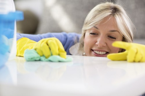 Cleaner using protective footwear and gear during carpet cleaning